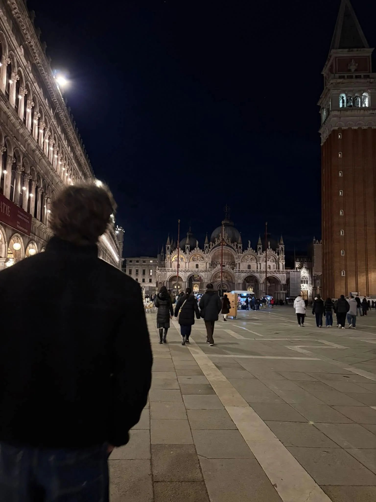Silhouette of Yente looking across St Mark's Square in Venice at night
